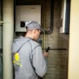 A technician examines solar power installations indoors, ensuring optimal performance.